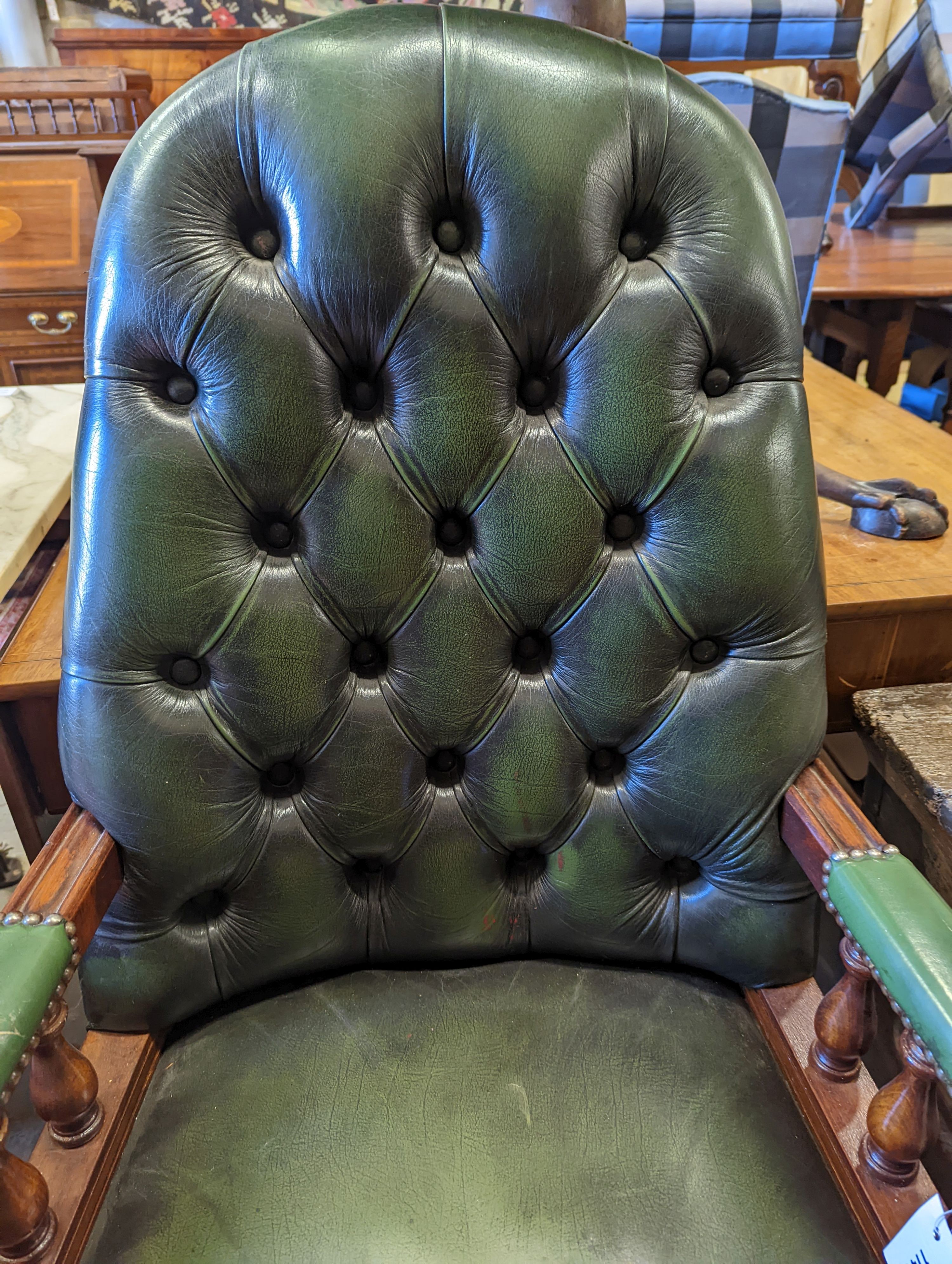 A green leather upholstered desk chair, width 60cm, depth 56cm, height 110cm
